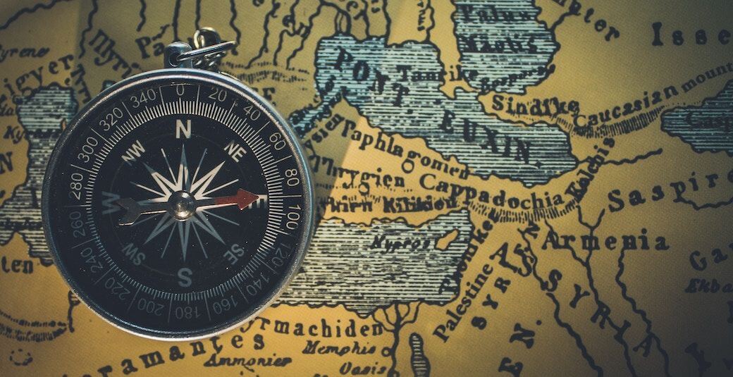 Compass resting on an old map